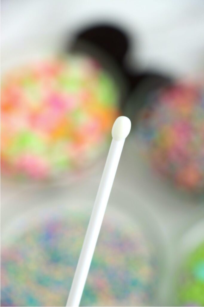 Closeup shot of cake pop stick dipped in melted almond bark