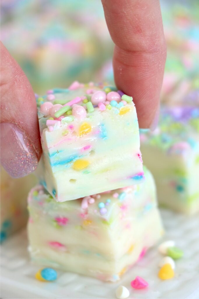Closeup shot of hand placing an Easter fudge square on top of another fudge square