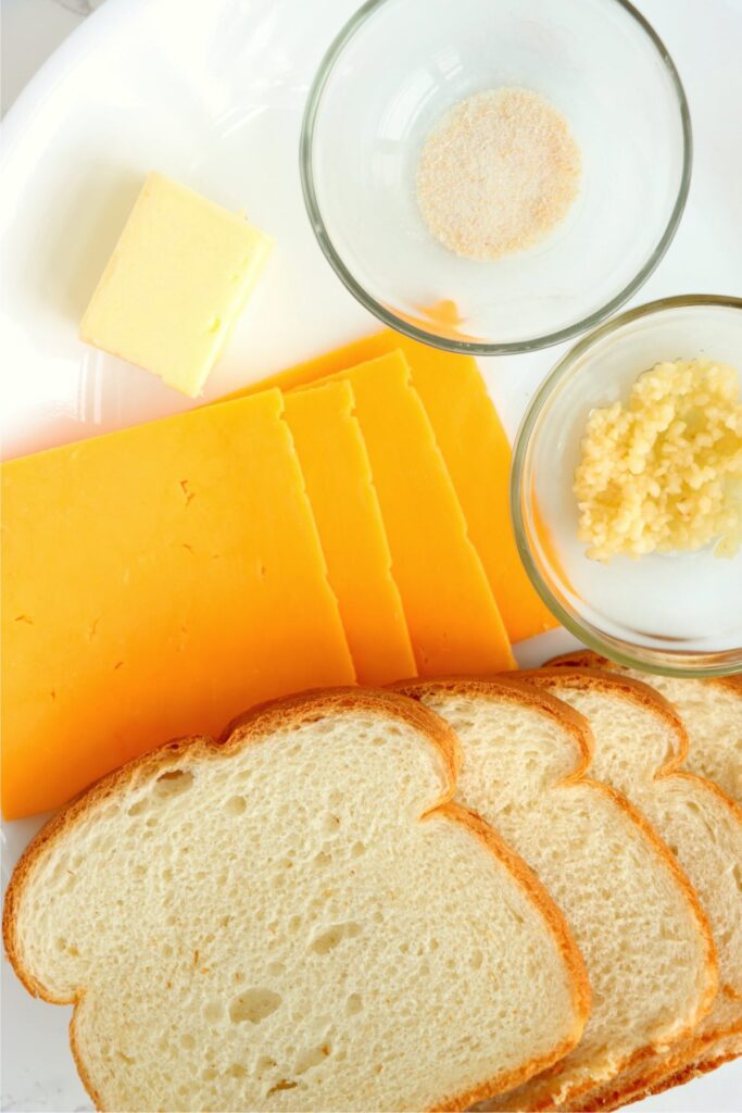 Overhead shot of individual grilled cheese ingredients on plate.
