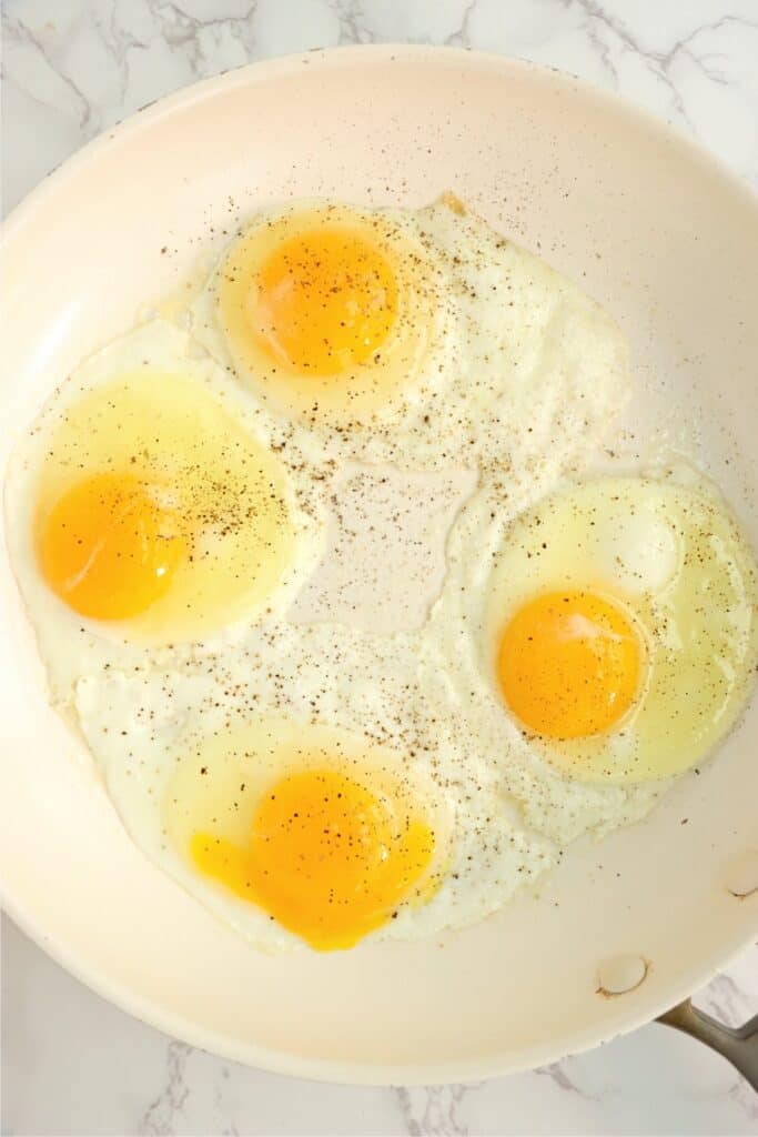 Overhead shot of eggs frying in a pan