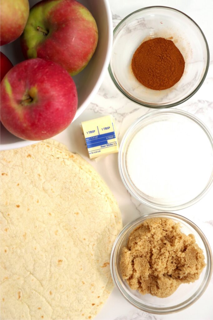 Overhead shot of individual homemade apple wrap ingredients on table.