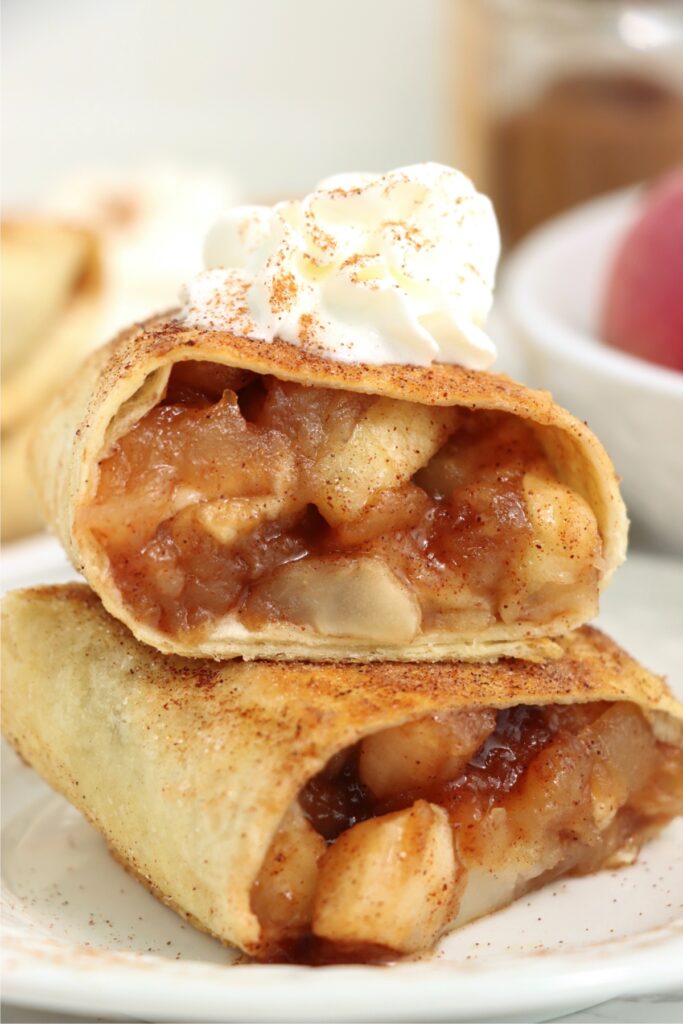 Closeup shot of two homemade apple wraps stacked atop one another on plate