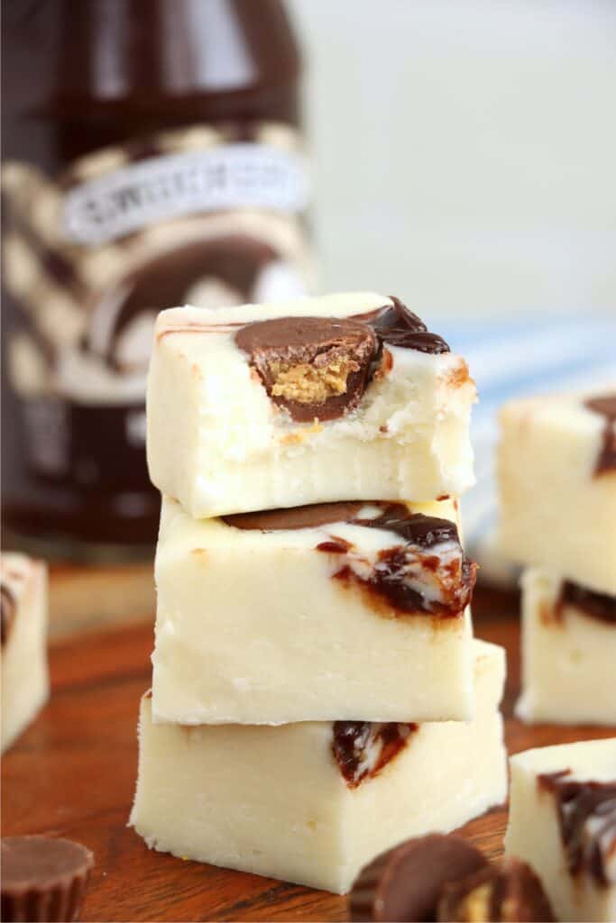 Closeup shot of three moosetracks fudge squares stacked atop one another with bite taken out of top square