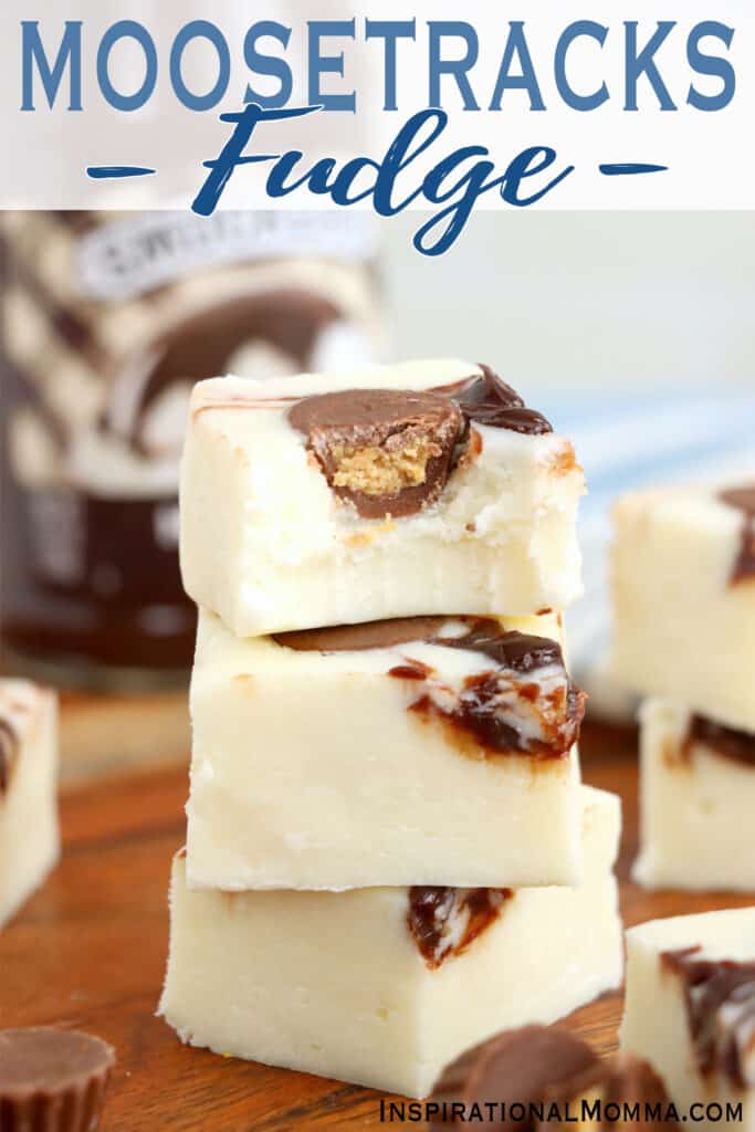 Closeup shot of three squares of Moosetracks fudge stacked atop one another with bite taken out of top square. 