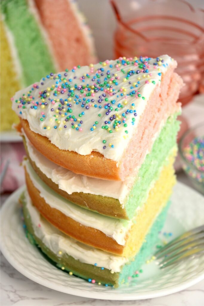 Closeup shot of slice of pastel layer cake on plate