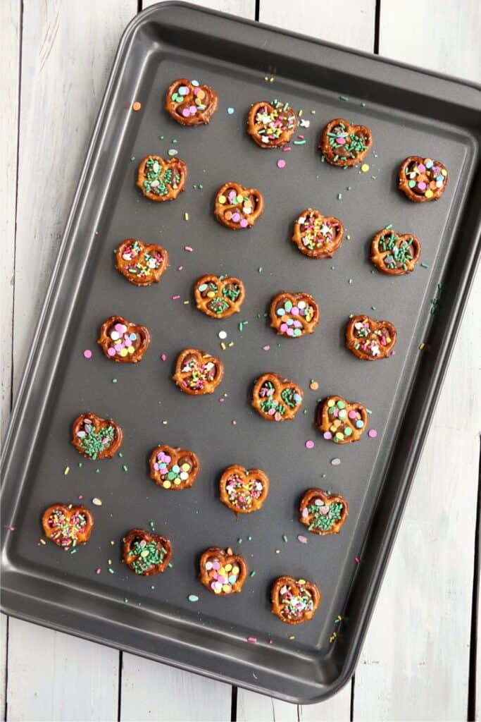 Overhead shot of baking sheet full of pretzel Rolo bites.