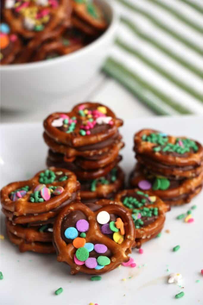 Closeup shot of pretzel Rolo bites stacked atop one another on parchment paper