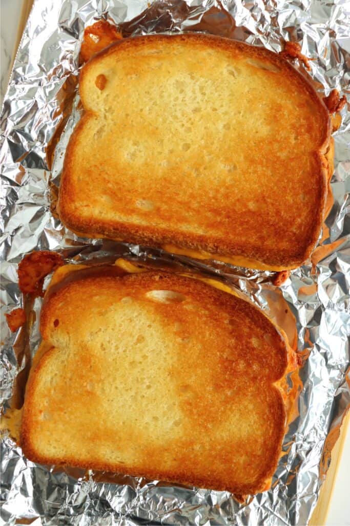 Overhead shot of two toater oven grilled cheese sandwiches on foil