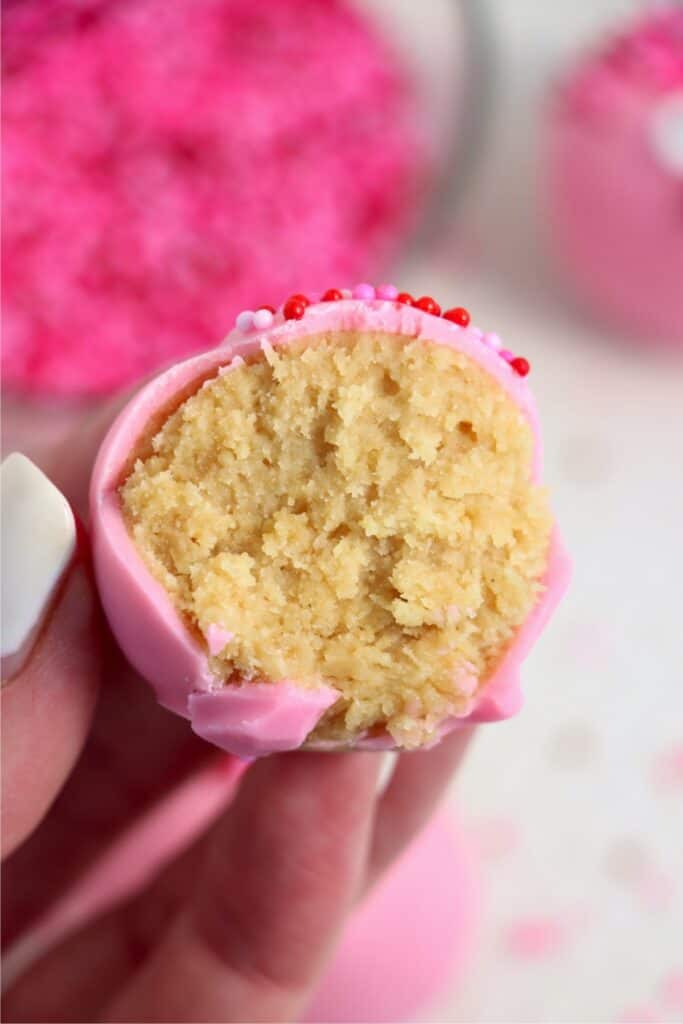 Closeup shot of hand holding Valentine Oreo truffle cut in half