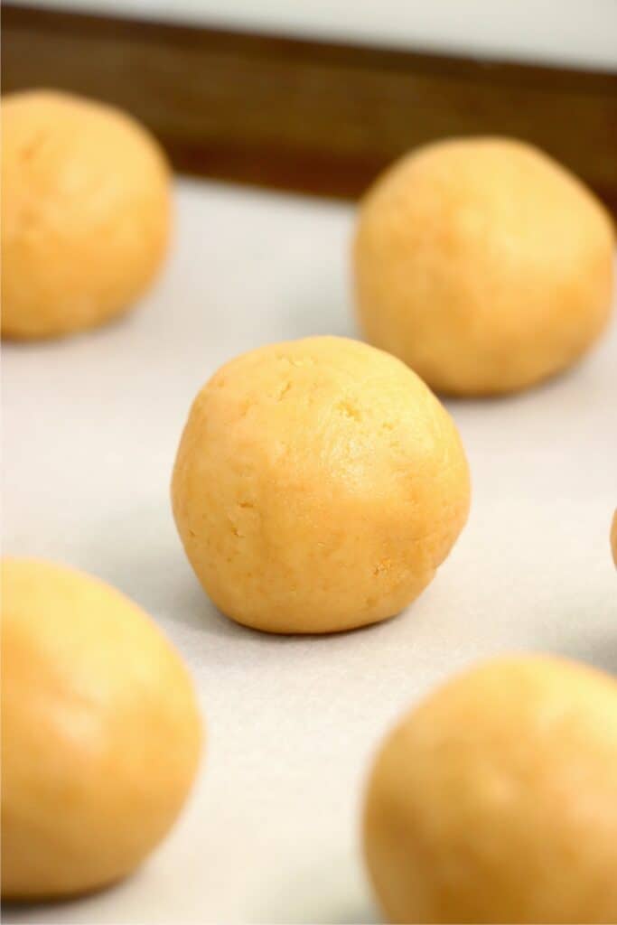 Closeup shot of Oreo balls on baking sheet lined with parchment paper