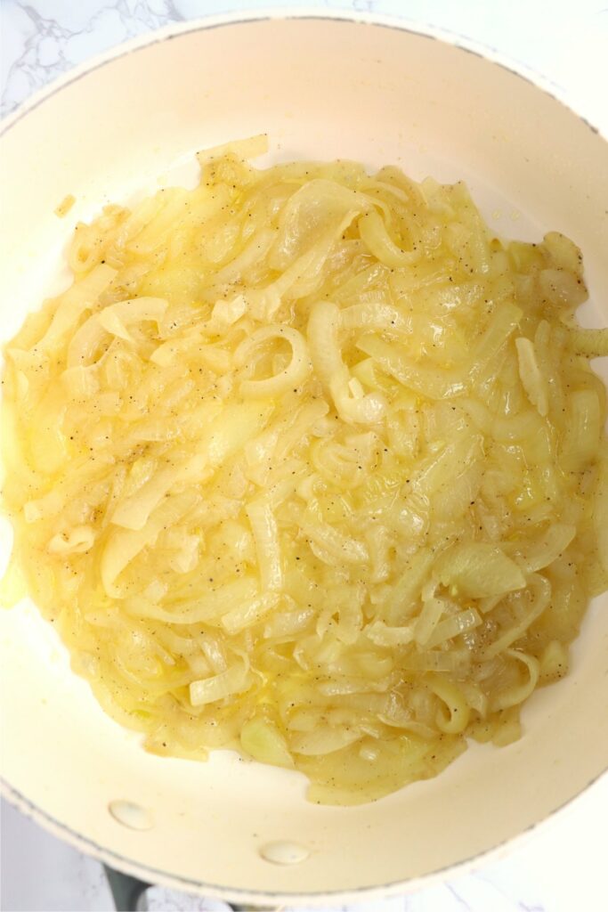 Overhead shot of cooked onions in skillet.