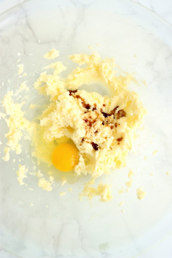 Closeup overhead shot of creamed butter and sugar with eggs in mixing bowl