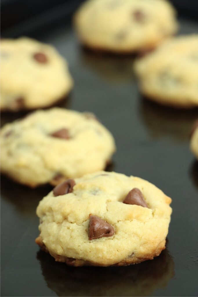 Closeup shot of baked chocolate chip cookies on baking sheet