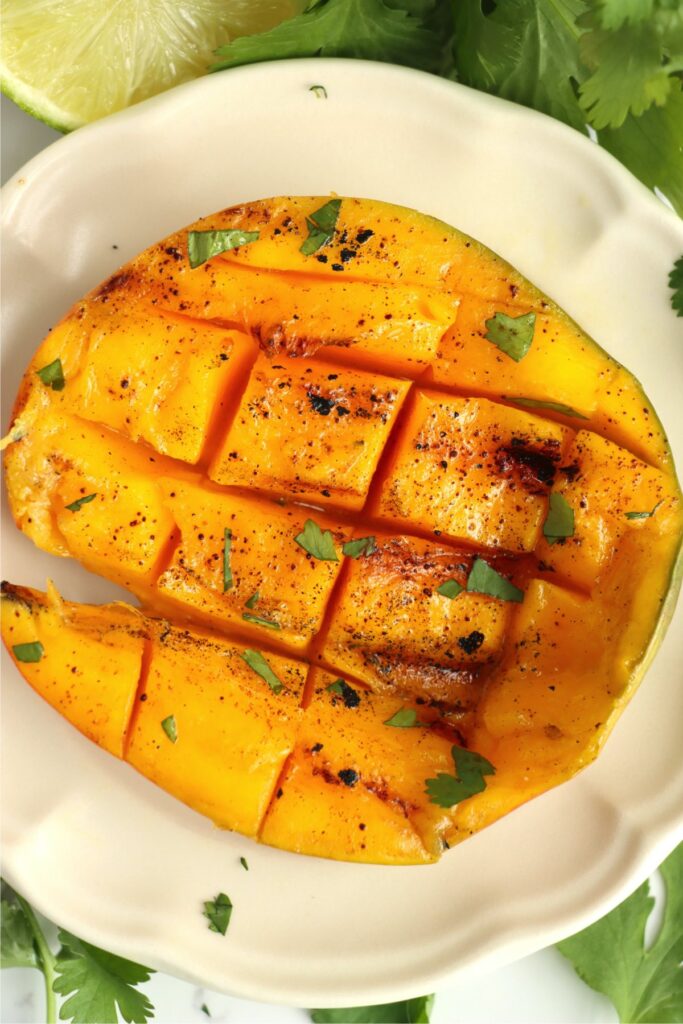 Overhead shot of grilled mango on plate. 