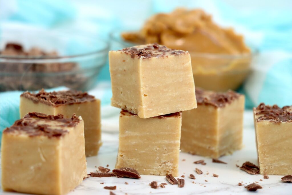 Closeup shot of squares of no bake peanut butter fudge on plate