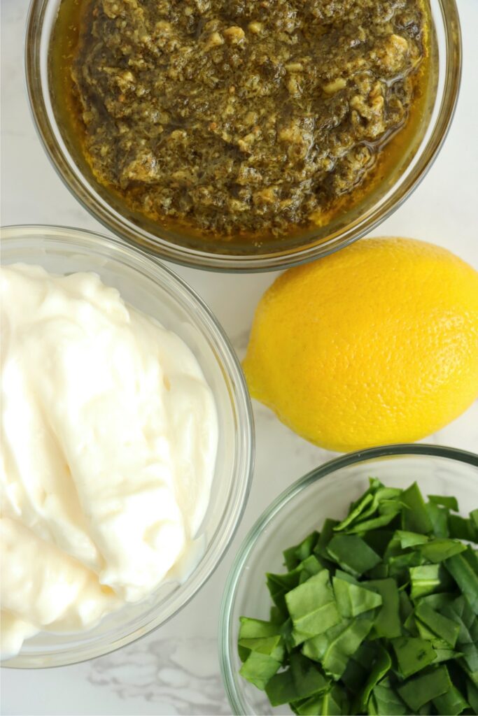 Overhead shot of individual pesto may ingredients on table