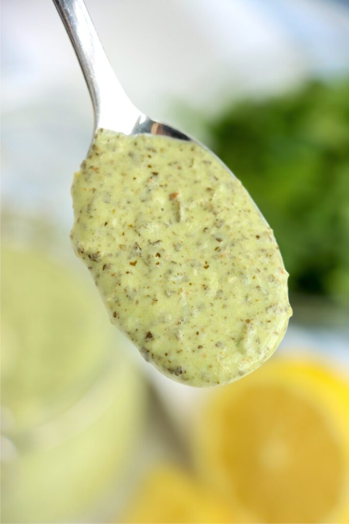 Closeup shot of spoonful of pesto mayo