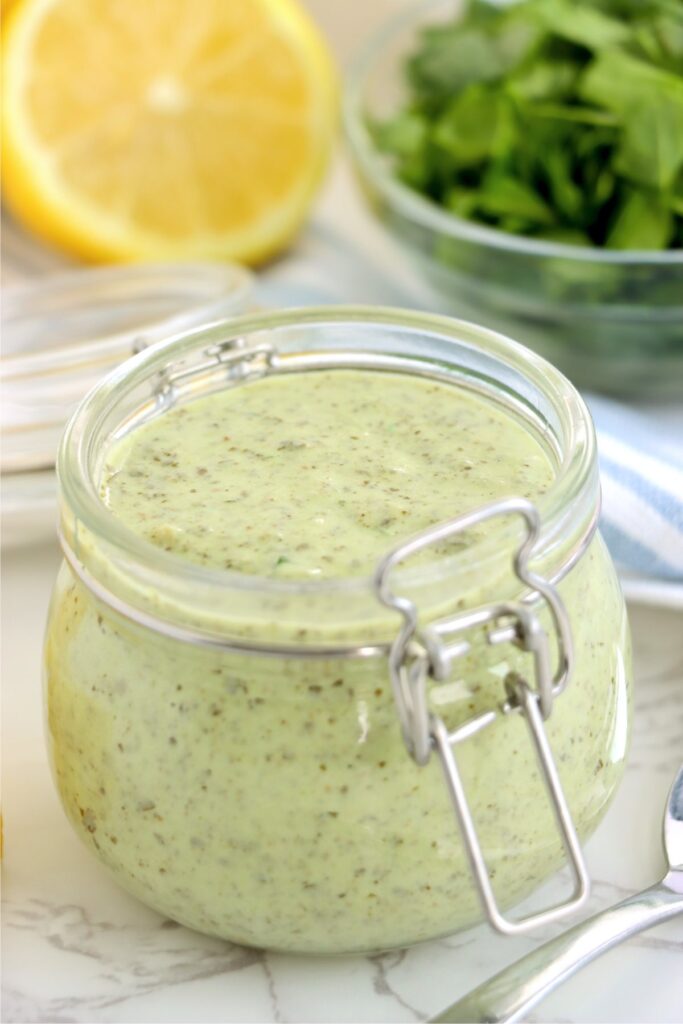 Closeup shot of pesto mayo in glass jar