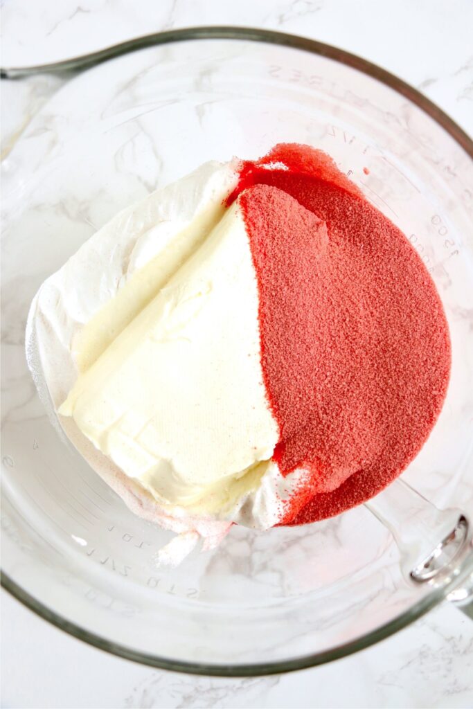 Overhead shot of all raspberry Cool Whip dessert ingredients in mixing bowl