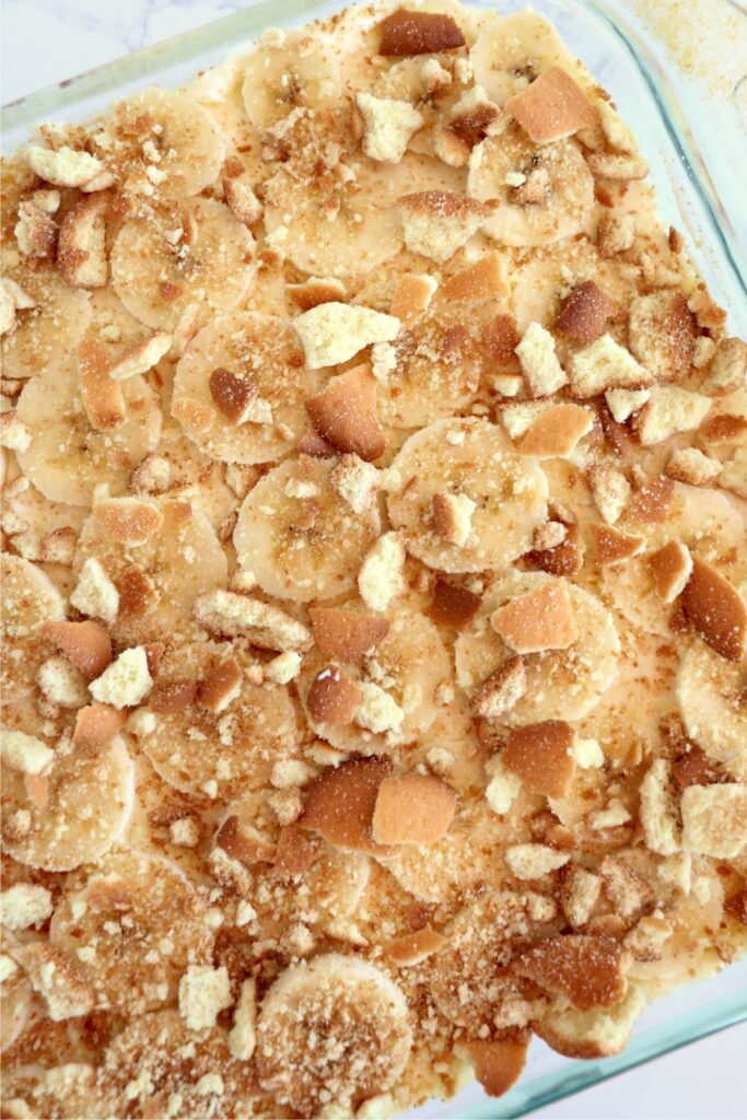 Closeup overhead shot of banana pudding lasagna in baking dish