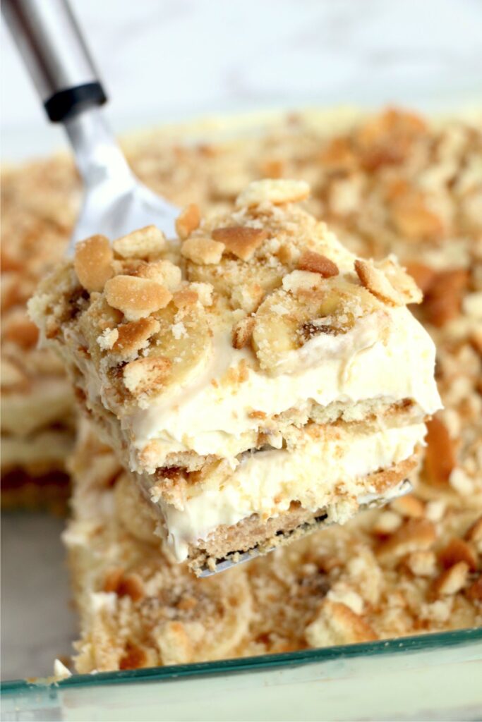 Closeup shot of slice of banana pudding lasagna on spatula.