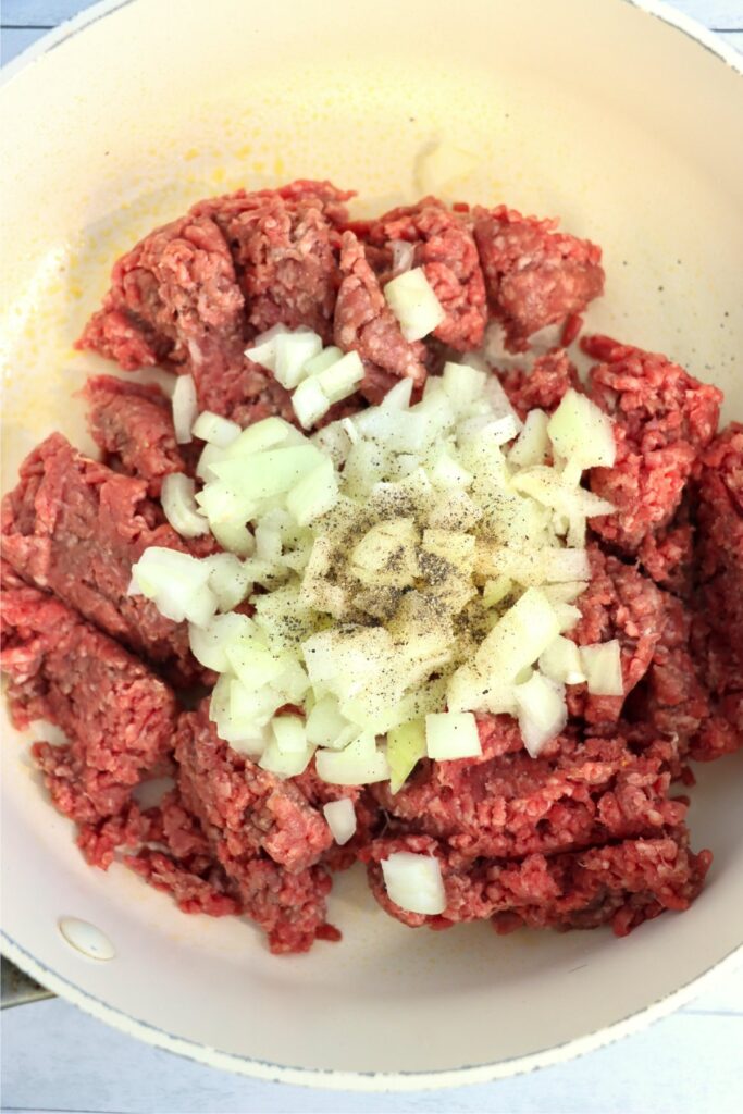 Closeup overhead shot of beef and onions in skillet