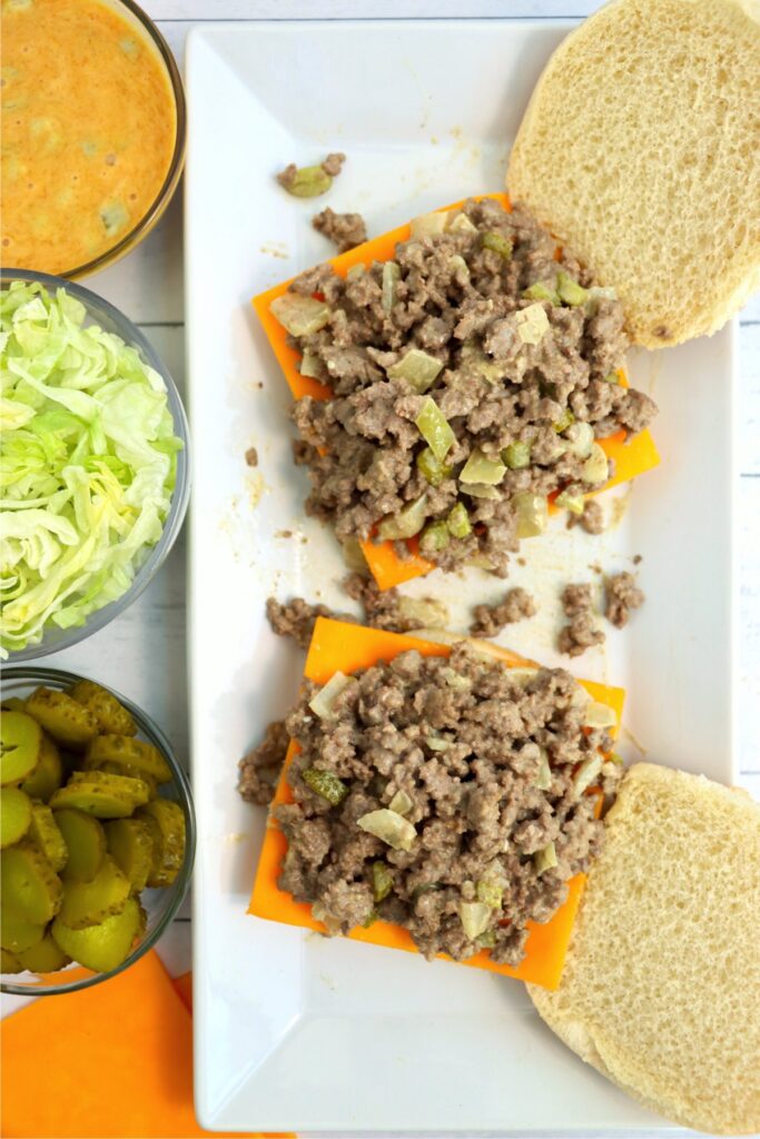 Overhead shot of bun topped with cheddar cheese slice and Big Mac sloppy Joe mixture