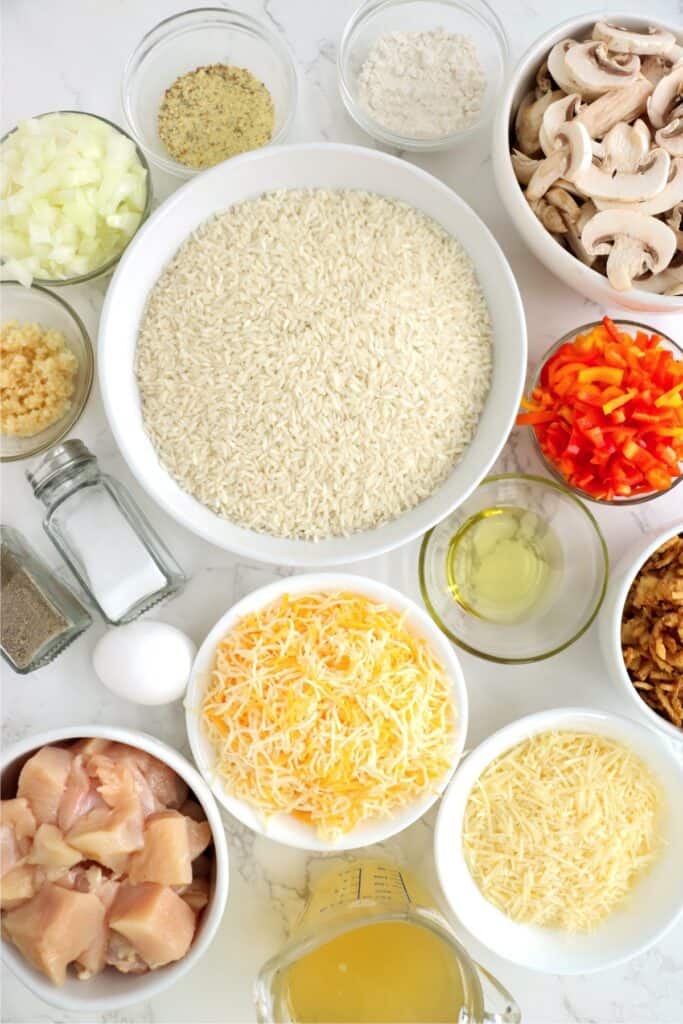 Overhead shot of individual chicken rice crust pie ingredients in bowls on table