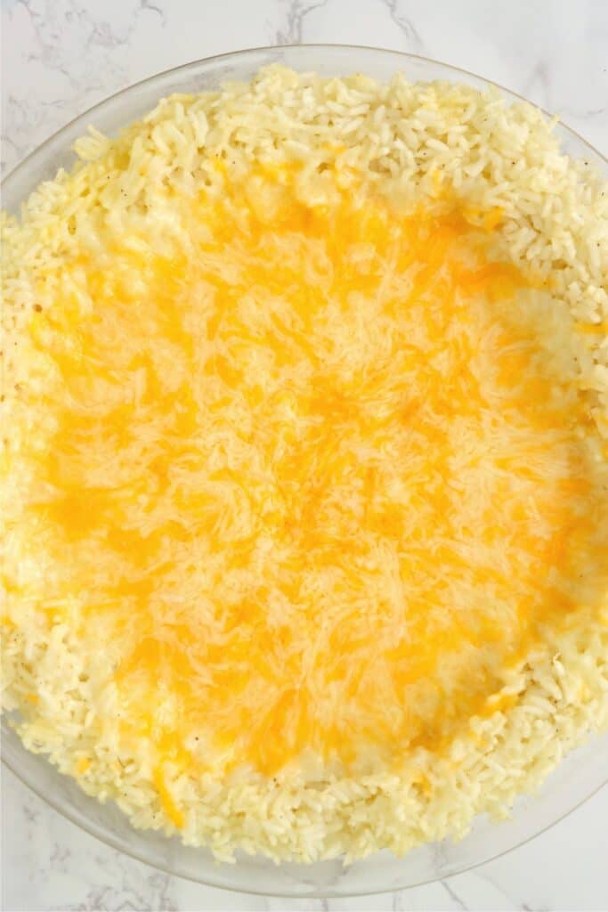 Overhead shot of baked rice crust with melted cheese on top. 