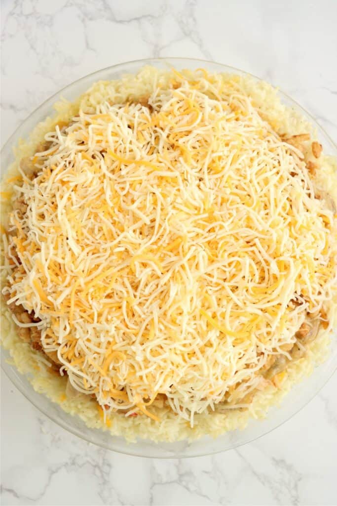 Overhead shot of chicken rice crust pie topped with French fried onions and cheese. 