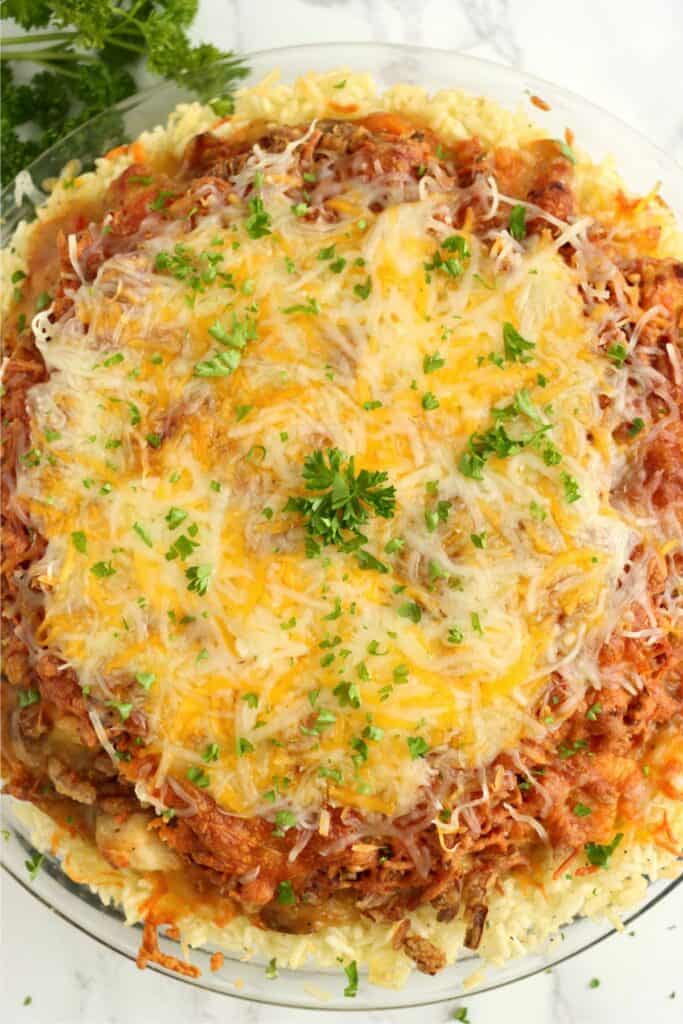 Closeup overhead shot of cheesy chicken rice crust pie. 