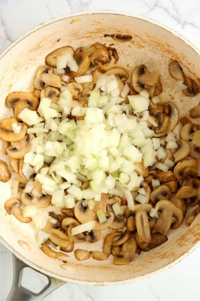 Overhead shot of mushrooms and onions in pan