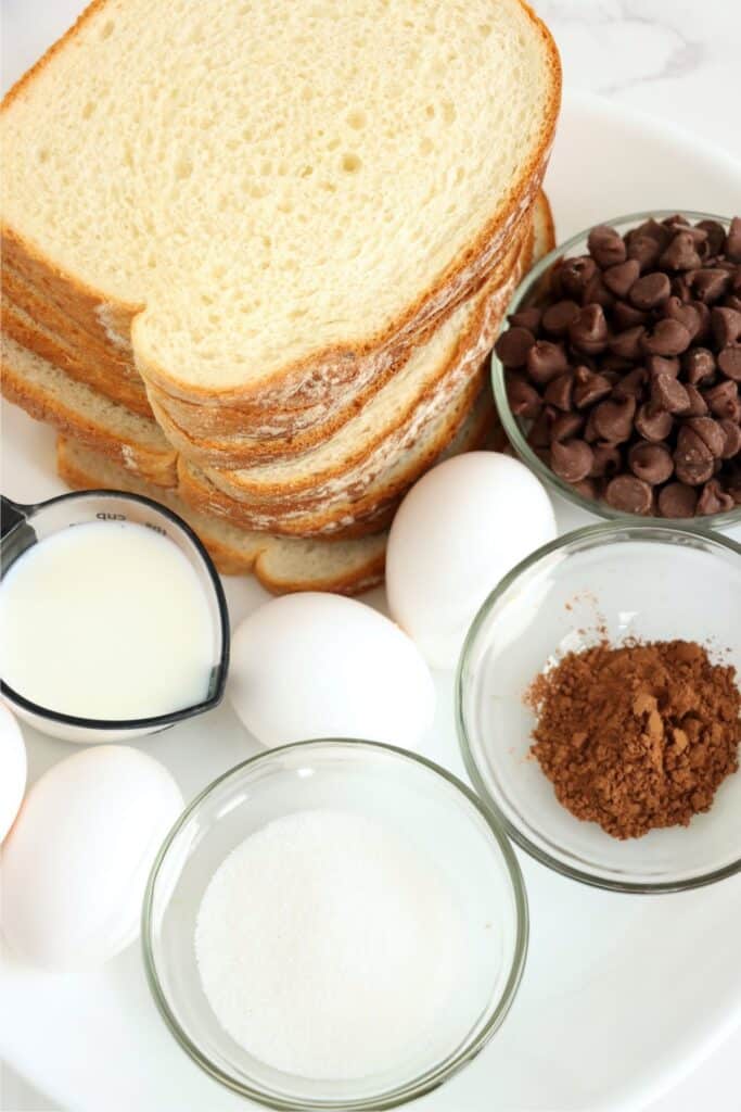 Overhead shot of individual chocolate French toast ingreidents in bowls on table