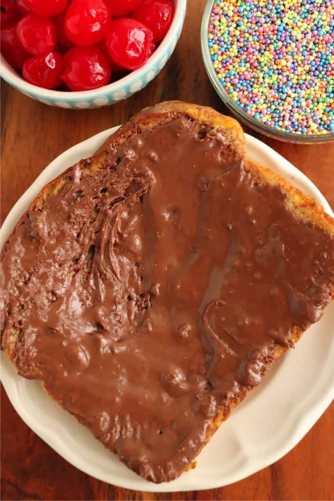 Overhead shot of chocolate French toast topped with melted chocolate on plate