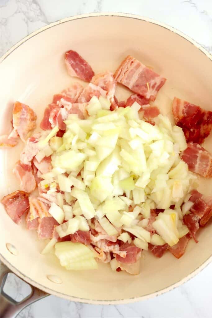 Overhead shot of bacon and onions in skillet.