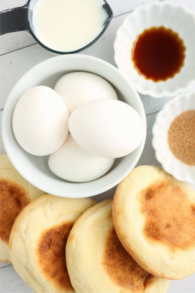 Overhread shot of individual English muffin French toast ingredients on plate