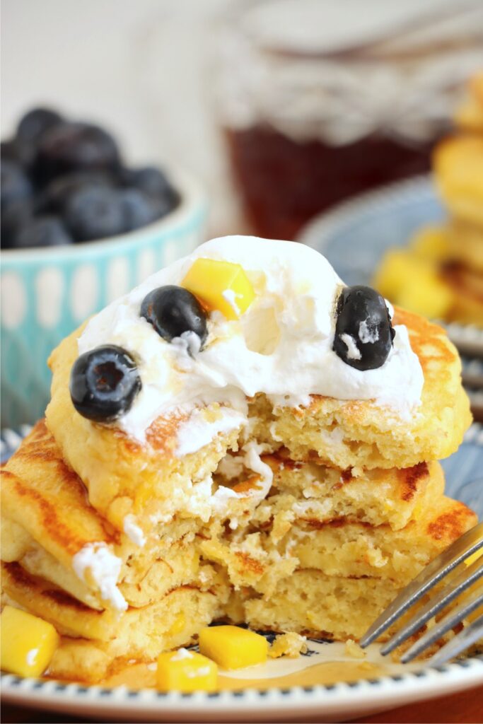 Close up shot of mango pancake stack with slice removed