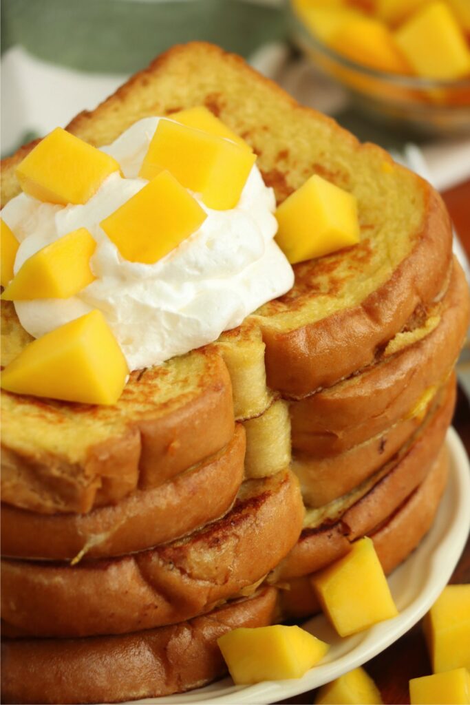 Closeup shot of stack of mango French toast on plate