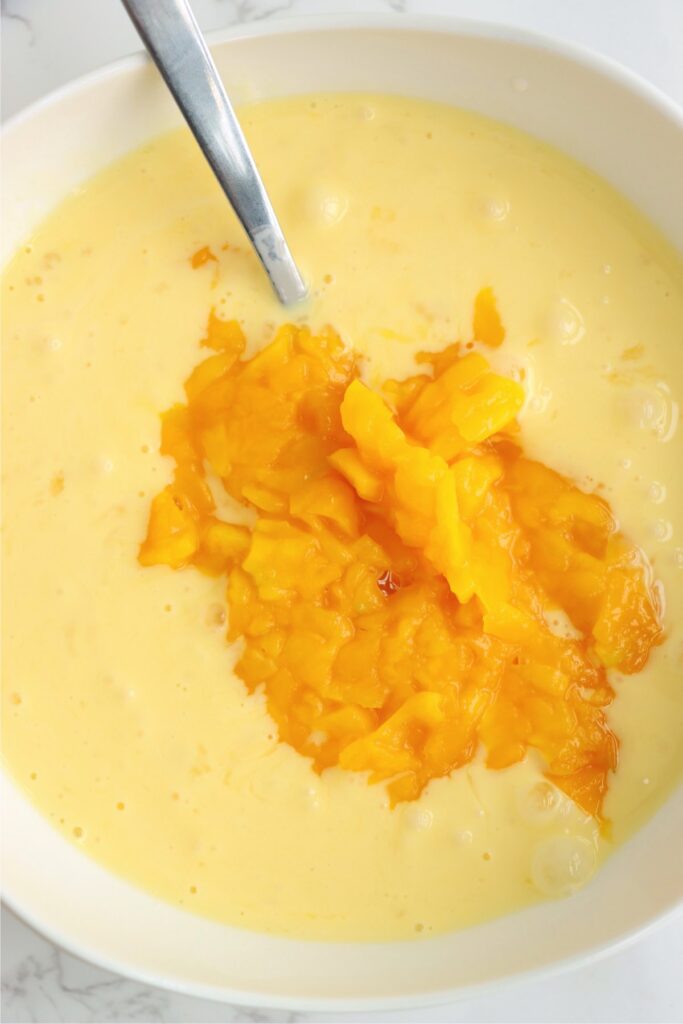 Mango and wet French toast ingredients in bowl