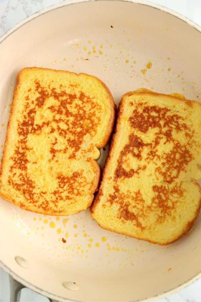 Overhead shot of golden brown mango French toast in skillet