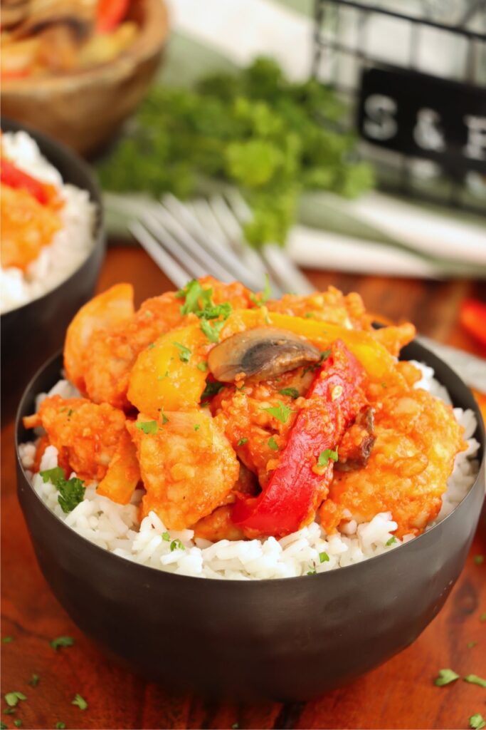 Closeup shot of bowlful of red chicken and rice.