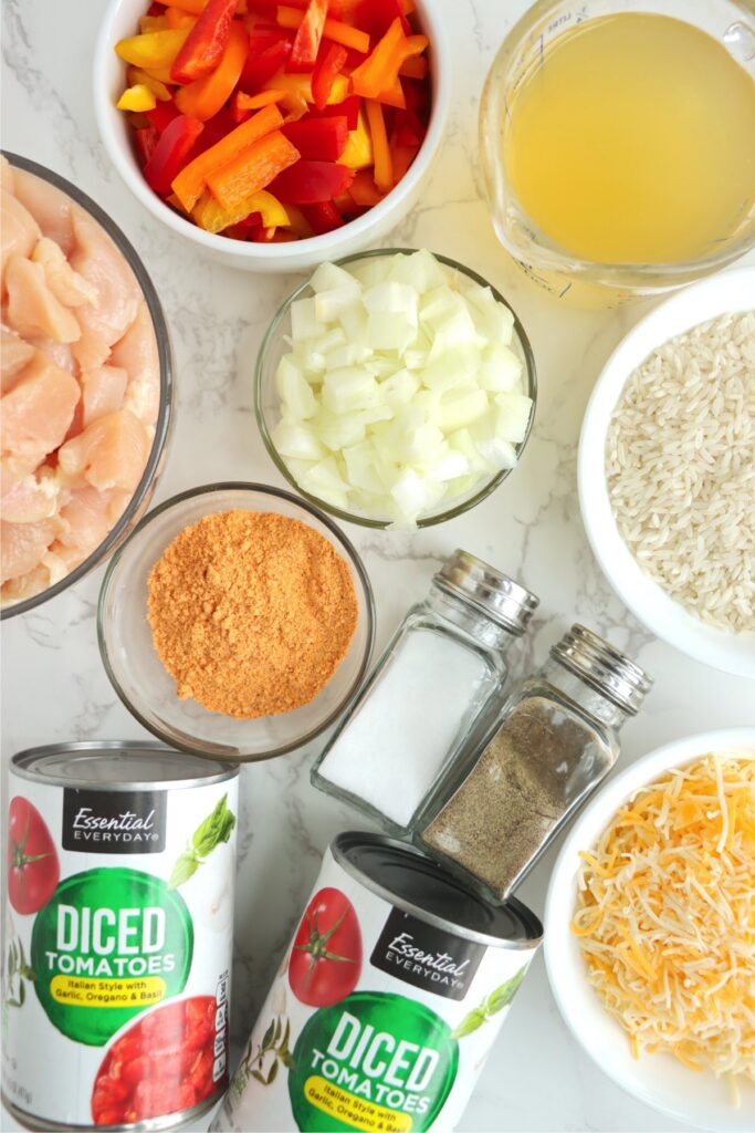 Overhead shot of individual slow cooker taco chicken and rice ingredients on table