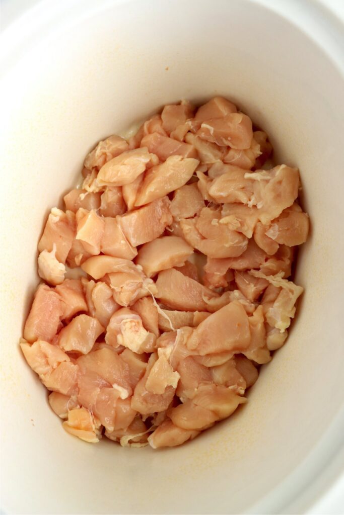 Overhead shot of chicken cubes in slow cooker