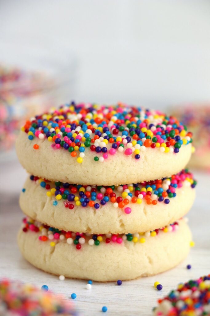 Closeup shot of sprinkle sugar cookies stacked atop one another on table