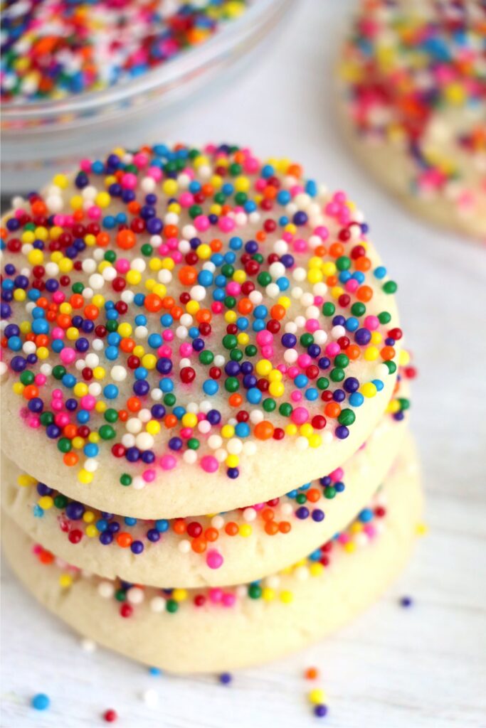 Closeup overhead shot of sprinkle sugar cookies stacked atop one another. 