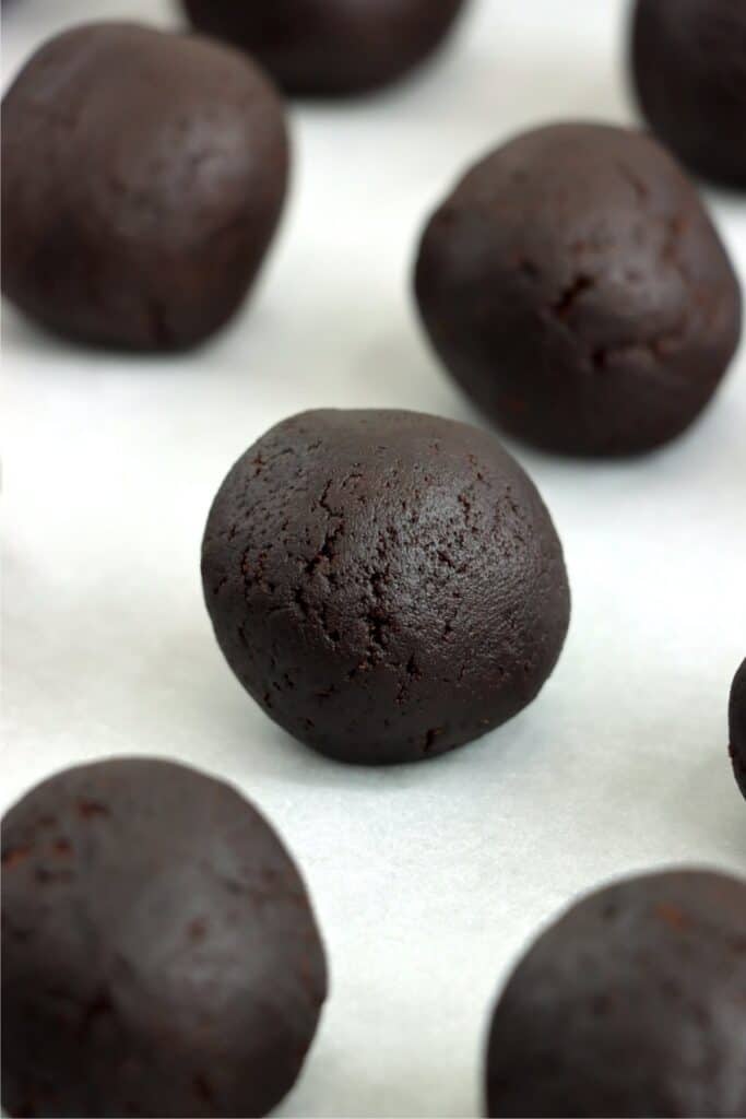 Closeup shot of chocolate cake balls on baking sheet