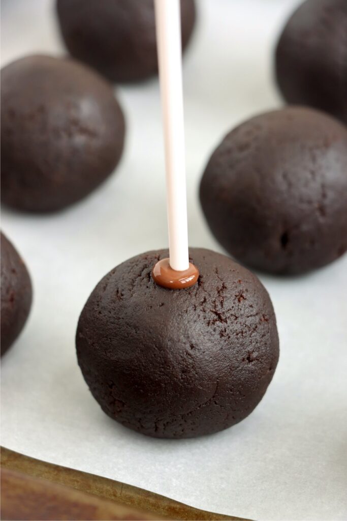 Closeup shot of cake ball with popsicle stick in it.