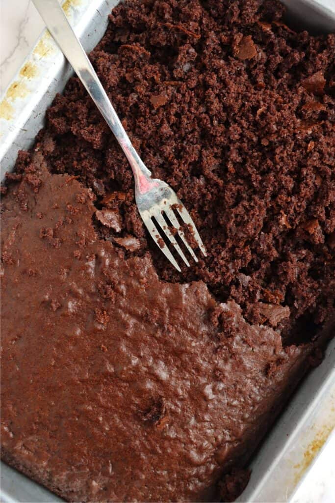 Closeup shot of chocolate cake being crumbled with fork