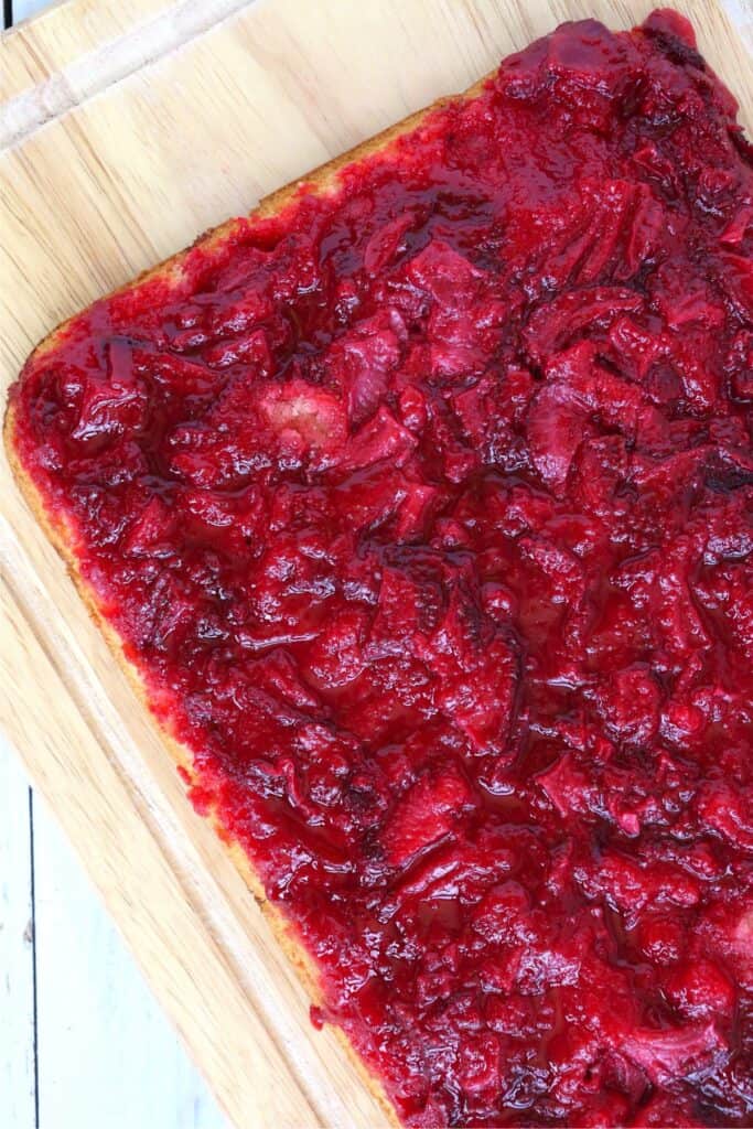 Closeup shot of eas strawberry dump cake on cutting board.