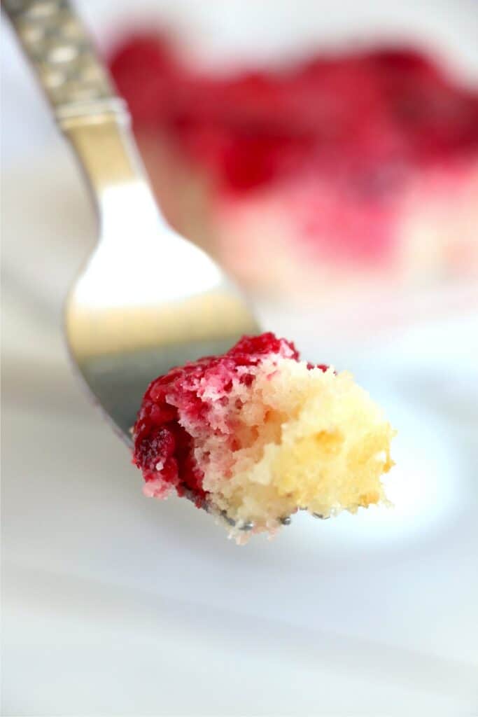 Closeup shot of forkful of easy strawberry dump cake.